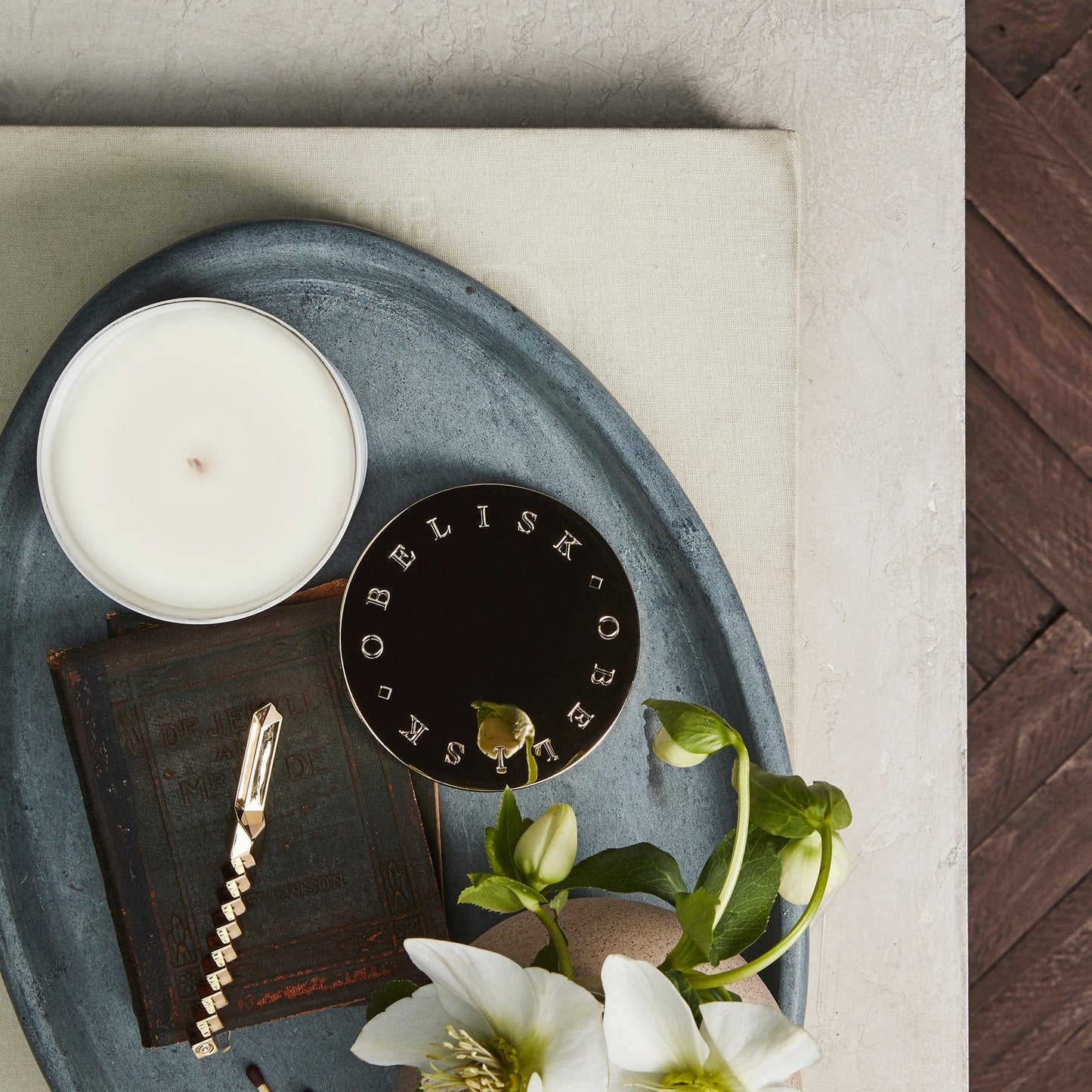 OBELISK gold-platted candle lid shown with coca leaf candle and snuff