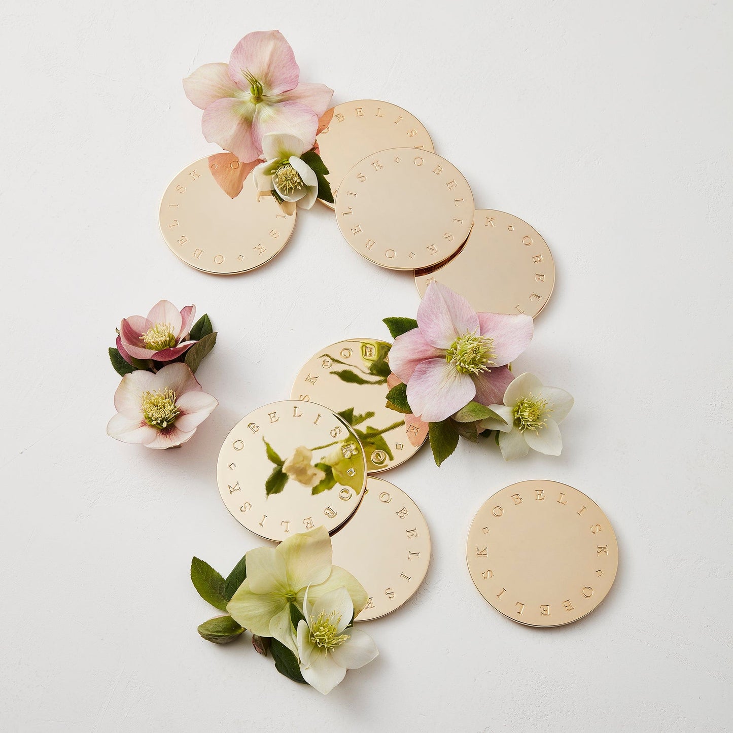 OBELISK gold-plated candle lids with florals